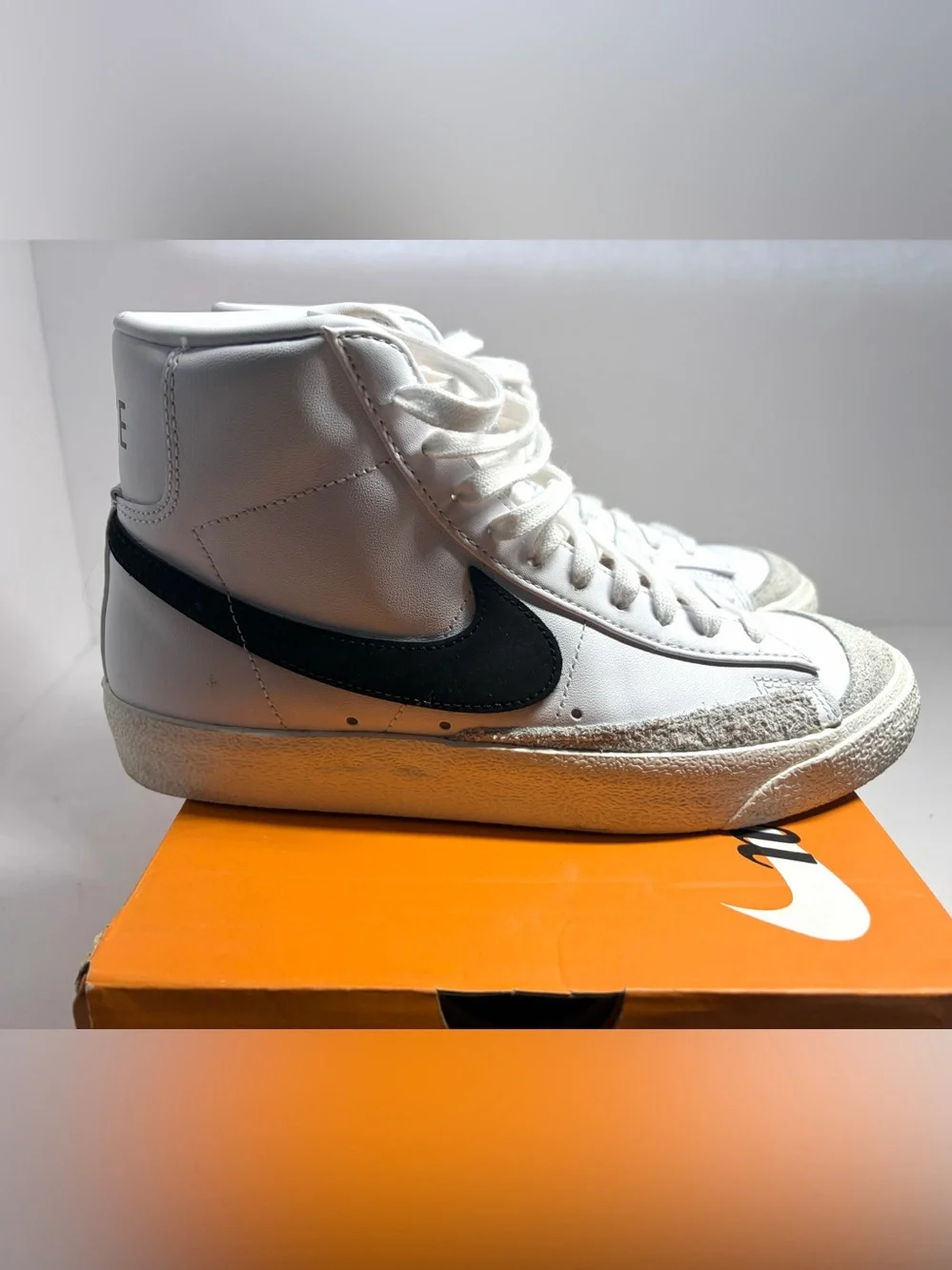 Nike unisex White High-Top Sneakers with Black Swoosh and Yellow Tongue Tab
